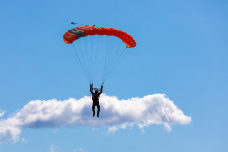 parachute in the sky. Skydiver is flying a parachute in the blue sky. high quality photoの写真素材