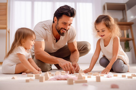 A dad and his daughters are assembling a construction set on the floor. Child care and development concept. High quality photoの素材