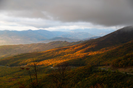 A beautiful sunset illuminates the outskirts of the mountain range, creating a unique landscape and giving the mountains a special charm.の写真素材