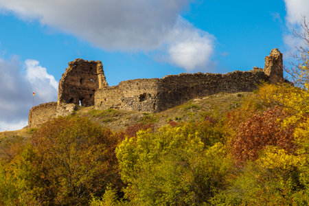 view of a ruined fortress in Ossetia, towering on a hill of a mountainの写真素材