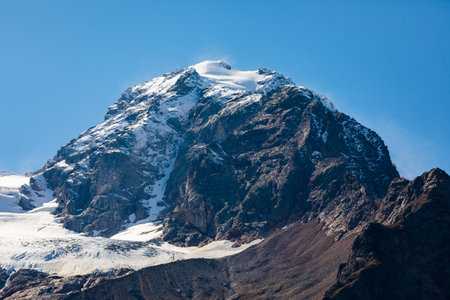 Beautiful panoramic view of snow-capped mountains shrouded in a soft white blanket of snowの写真素材