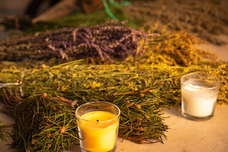 A scattering of natural herbs in the hands of a master who creates magic brooms for the bath. Their fragrance will fill the space of coziness and tranquility, adding relaxation and well-being to you.の写真素材