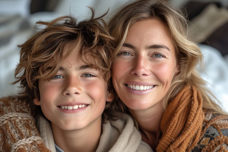 a woman and a boy are smiling for the cameraの素材