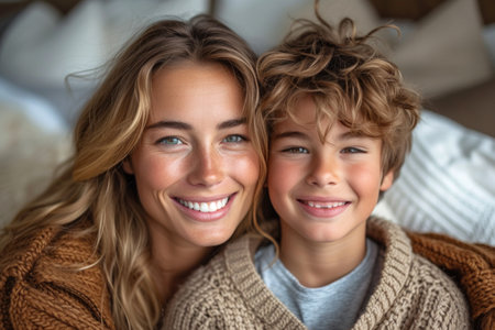 A woman and a boy are displaying bright smiles for the camera, showing their happy facial expressions. Their noses, hair, skin, and eyelashes are also highlighted in the photoの素材