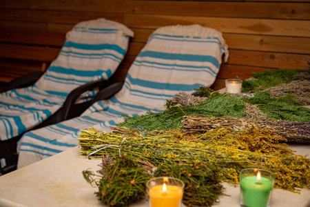 Various terrestrial plants and flowers are displayed on a wooden table in a sauna, creating a serene and natural landscapeの写真素材