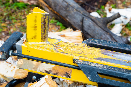 Mechanical action of a wood splitter with destructive force on a birch log.の写真素材