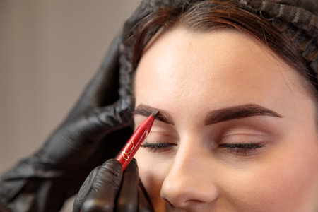 The specialist sketch carefullyes lines for a lasting and attractive makeup look.の写真素材