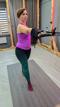 Woman doing cable row exercise with resistance band in gymの写真素材