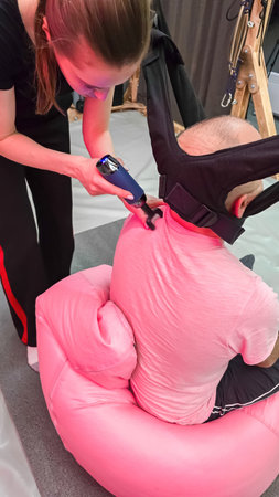 Therapist performing cervical spine traction therapy on patientの写真素材