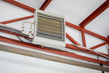 Powerful industrial heater warming a large factory or warehouse, ensuring comfortable working conditionsの写真素材