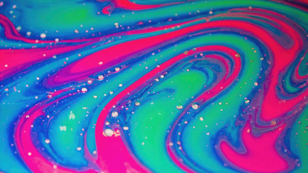 Vibrant pink, blue, and green fluids swirling together, forming a mesmerizing abstract pattern with small bubbles adding to the visual textureの素材