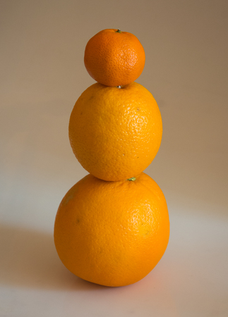Two oranges and a tangerine look like a mini snowmanの写真素材