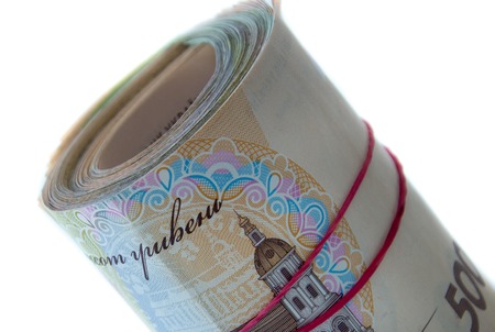 Stack of 500 hryvnya rolled on white background