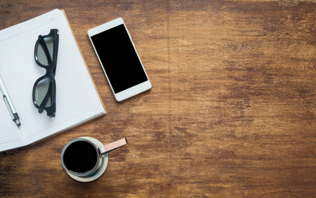 Coffee with blank notebook, glasses and phone with black blank space, flat lay. Top viewの写真素材