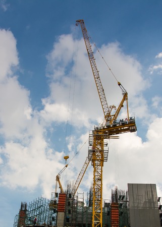 Tower crane on industrial building under constructionの写真素材