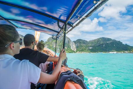 PHI PHI ISLAND, THAILAND - MARCH 31, 2017: Tourists make journey on long-tail boat to the island in the daytimeのeditorial素材