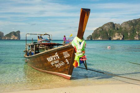 PHI-PHI, THAILAND - APRIL 30, 2017 : Taxi long-tail boat moored at the tropic beachのeditorial素材