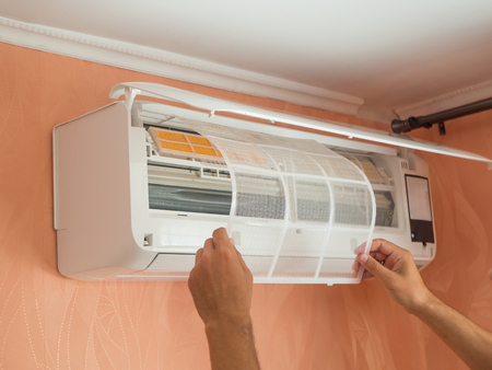 Changing filter in air conditioner on the wall at home. The Concept of Safe and Healthy Housingの写真素材