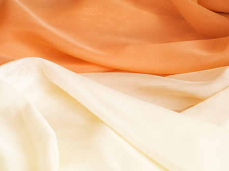 Close up of cream and beige colors of fabric with undulation. Texture, background, pattern. Abstract background of luxury cream and beige fabric textureの写真素材