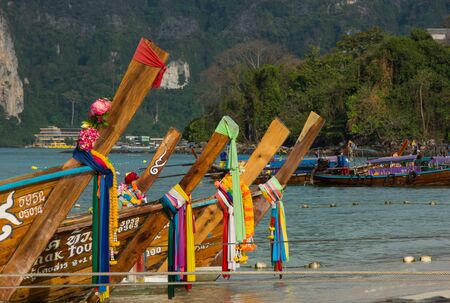 Phi Phi Islands, Thailand - March 27, 2017: Thai taxi boat noses with decoration on the shorelineのeditorial素材