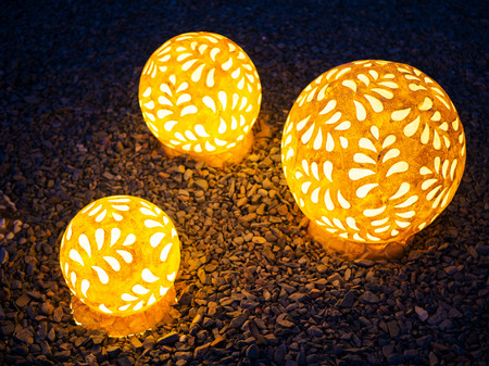 Three glowed spheres on the dark gravel background, outdoor decorationの写真素材