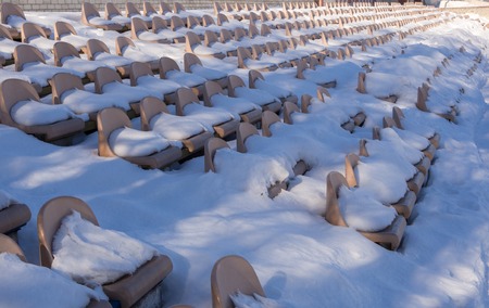 Rows of empty stadium bleachers in the snowの写真素材