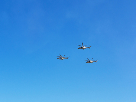 Airshow. Three helicopters flying in the blue sky