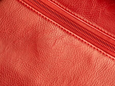 Close-up of purse zipper in red color, place for text