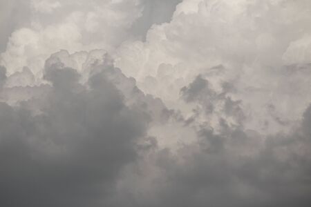 The Dark gray dramatic sky with large clouds in rainy seasons.の写真素材