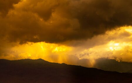 Dark gray dramatic sky with large clouds before rain in evening.の写真素材