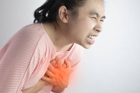 Asian young woman suffering from chest pain caused by heart disease.の写真素材