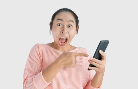 Asian woman angry and yelled what she see in the smartphone and pointing it, Isolated on white...