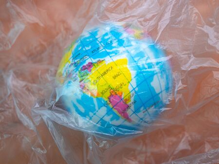 The earth in plastic bag, Global warming due to pollution by plastic debris. The concept of Earth...