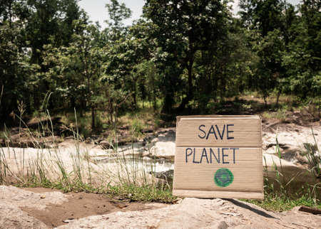 The nature conservation sign on stream flowing background. The concept of World Environment Day. Zero waste.の写真素材