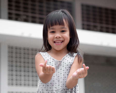 Happy little child girl having fun to play on home backyard. Stay at home to quarantine from...