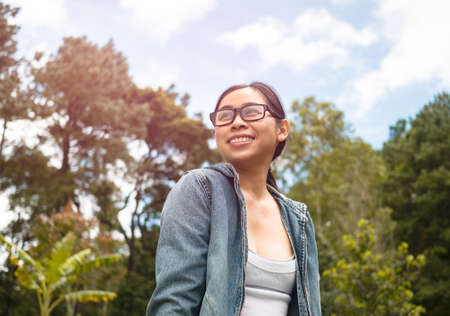 Happy female tourists enjoying the nature on a sunny summer day in spring garden. Travel and happiness concept.の写真素材