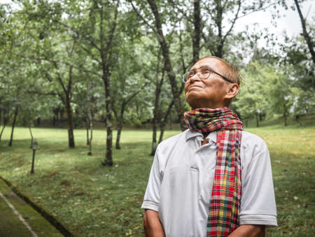 Portait of senior man enjoying nature in the park. Senior retired man enjoying the freedom of retirement.の写真素材