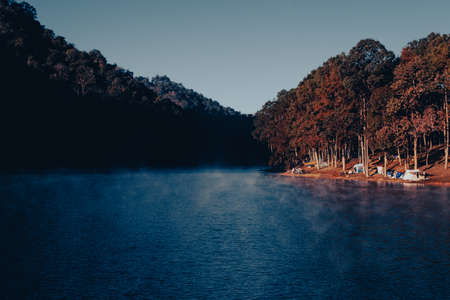 Camping tents in the pine tree forest by the lake with the misty over river at sunrise at Pang Oung Lake (Pang Tong reservoir), Mae hong son, Thailand.のeditorial素材