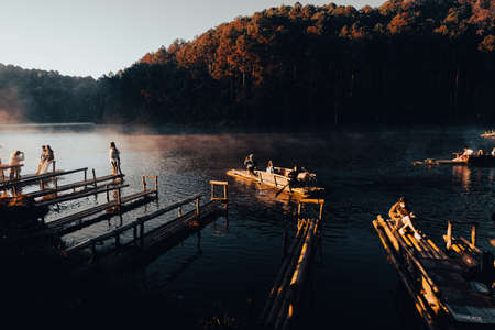 Mae Hong Sorn, Thailand - December 17, 2021 : Beautiful lake over the misty river at sunrise with traveler on the Bamboo raft. Morning view at Pang Oung Lake (Pang Tong reservoir), Mae hong son, Thailのeditorial素材