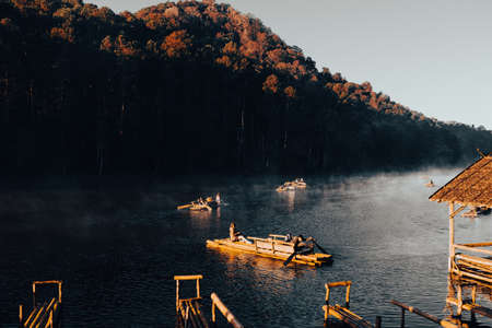 Mae Hong Sorn, Thailand - December 17, 2021 : Beautiful lake over the misty river at sunrise with traveler on the Bamboo raft. Morning view at Pang Oung Lake (Pang Tong reservoir), Mae hong son, Thailのeditorial素材