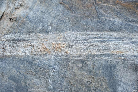 Close-up texture of a natural river bank stone wall in a mountain forest in northern Thailand. Stone...