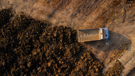 Aerial view of heavy earthmovers in construction site.