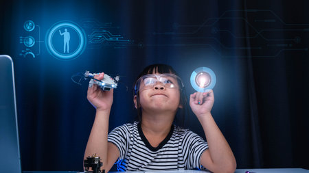 Child learning repairing getting lesson control toy drone in workshop, coding and solving engineering problem at home. Little Scientist School Project. STEM Education and Science technology concept.の写真素材