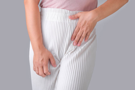 Woman with hands on her crotch isolated on white background. Female hand holding her crotch with pelvic pain or vaginal itching. gynecological problems. Health hygiene conceptの写真素材