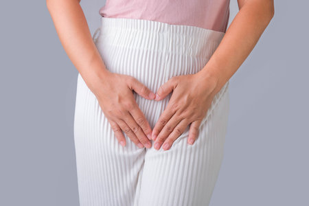 Woman with hands on her crotch isolated on white background. Female hand holding her crotch with pelvic pain or vaginal itching. gynecological problems. Health hygiene conceptの写真素材