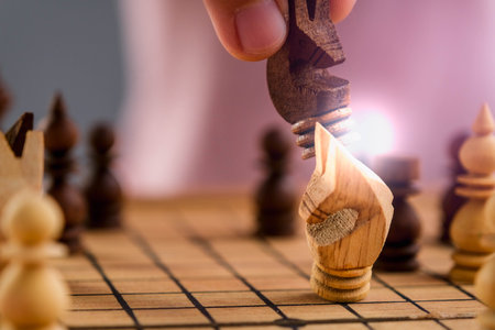Close-up of businessman hands playing chess game. Concept of business strategy and tactic.の写真素材