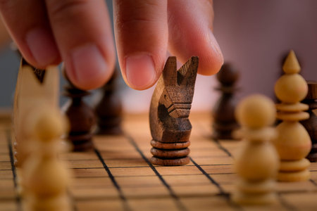 Close-up of businessman hands playing chess game. Concept of business strategy and tactic.の写真素材