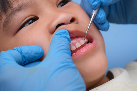 Close-up in the oral cavity of a healthy child with beautiful white teeth. Young girl opens her mouth to reveal healthy teeth, hard and soft palate. Dental and oral health checkの写真素材