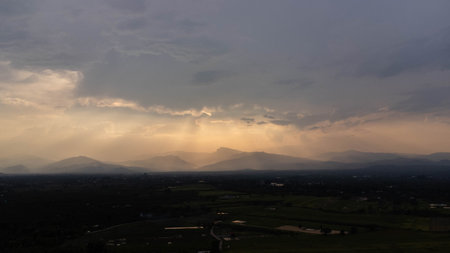 Mountains and beautiful clouds under sunset sky. Beautiful mountain landscape with golden sky.の写真素材