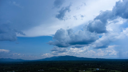 Green mountains and beautiful clouds under blue sky. Beautiful mountain landscape with bright sky.の写真素材